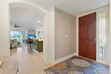 Foyer entrance with light tile patterned floors, b
