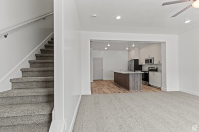 Staircase with carpet, recessed lighting, and a ceiling fan