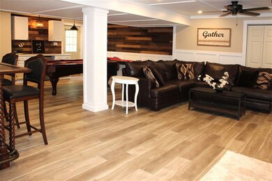 Another view of the lower level with walk out and dry bar area