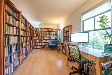 Office space with bookshelves and light wood-type