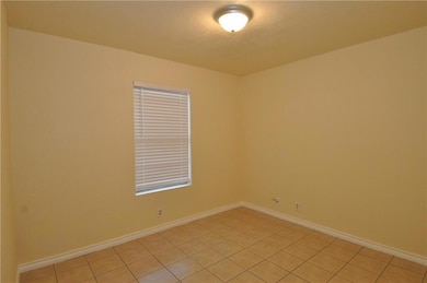 Unfurnished room with light tile patterned floors