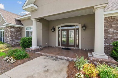 Property entrance with a porch, a shingled roof, s