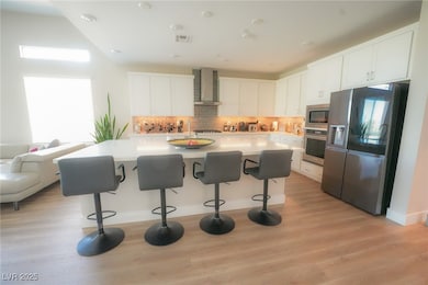 Kitchen featuring stainless steel appliances, wall