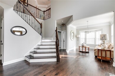 Stairs with natural light, hardwood flooring, and