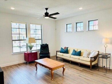Living room with ceiling fan, a healthy amount of 