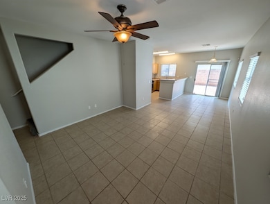 Unfurnished living room featuring light tile patte