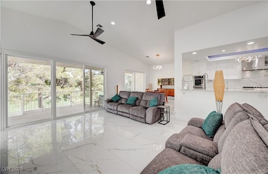 Living area with ceiling fan, light marble finish