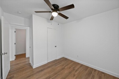 Unfurnished bedroom with a closet, ceiling fan, an