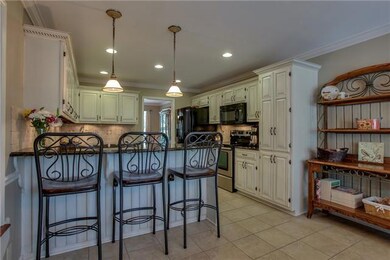 The handpainted and custom glazed cabinets are a work of art by themselves!  Add in the Tiled backspash, granite countertops, updated appliances, tiled floor, and you have a kitchen to love!