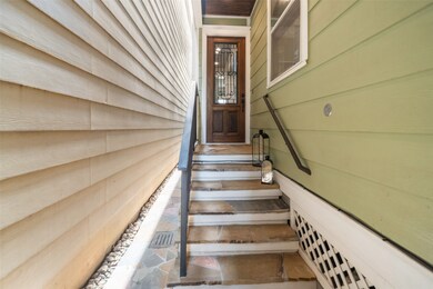 This photo shows a narrow entryway with steps lead