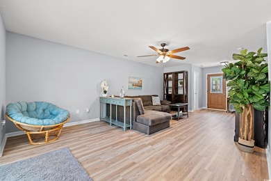 Living area with light wood finished floors, visib