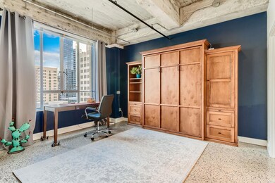 Office with a view of city, speckled floor, and b
