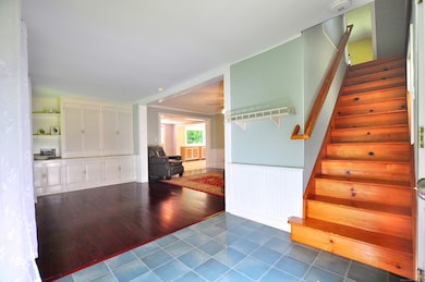 Entryway showing steps to second floor