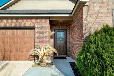 Entrance to property featuring brick siding