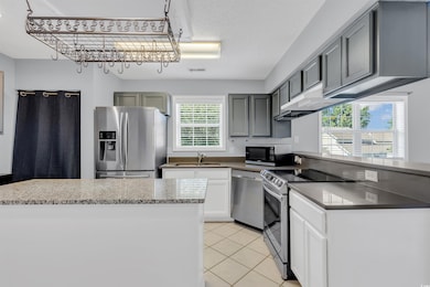 Kitchen with gray cabinets, stainless steel applia