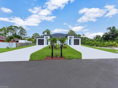 Contemporary home with an attached garage, concrete driveway, and stucco siding