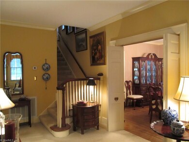 Charming view when entering the property with classic staircase to second level.