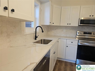 Quartz countertops and tiles backsplash