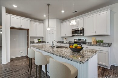 Kitchen.  Virtually staged -- no furnishings exist or are included in sale.