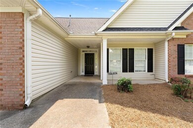 Property entrance with brick siding and roof with shingles