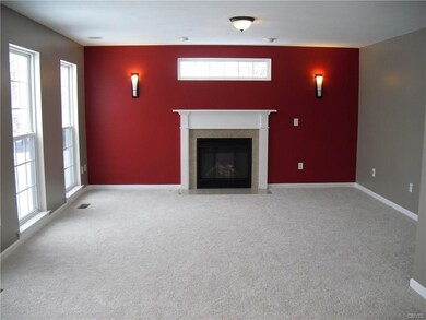 Family room with gas fireplace & transom window.