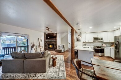 Living area featuring a ceiling fan, wood finished