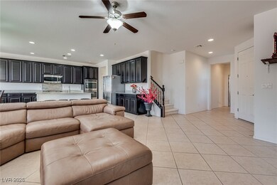 Living area with visible vents, stairway, light ti