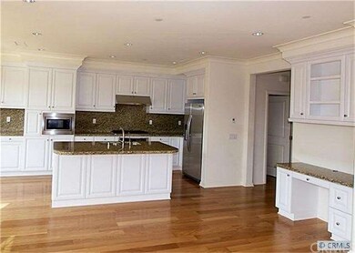 LOOKING FROM FAMILY ROOM INTO KITCHEN