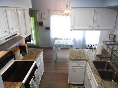 Kitchen with electric range oven, dark wood-style