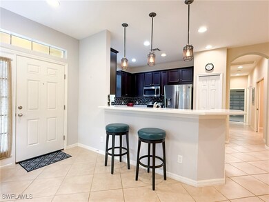 Kitchen with light countertops, appliances with st
