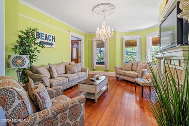 Living room with hard wood floors, high ceilings and great flow to near by den and dining room.