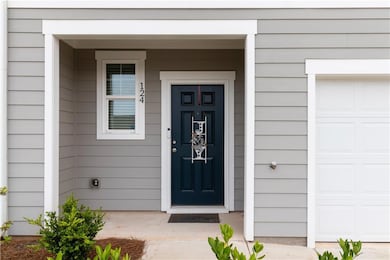 Doorway to property featuring an attached garage