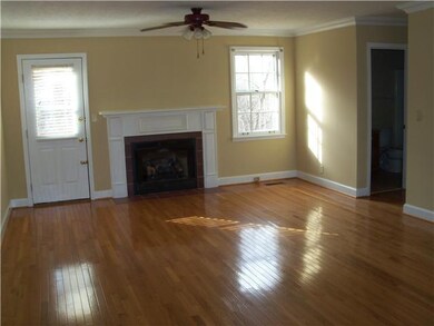 Living room has a gas fireplace. Beautiful oak flooring.