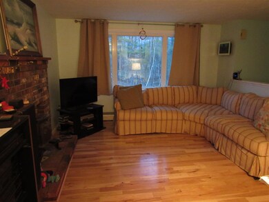 Open concept living room has hickory hardwood floo