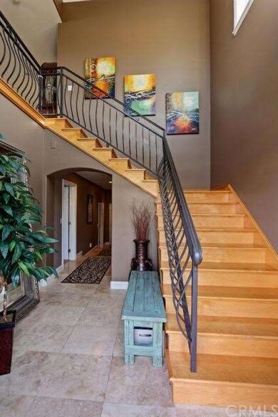 Travertine front entryway and winding staircase wi