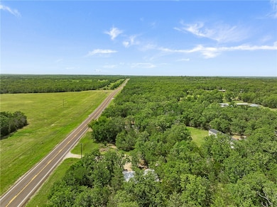 View of property location featuring a forest