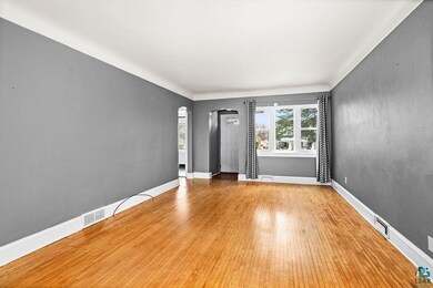 Unfurnished room with baseboards, visible vents, a