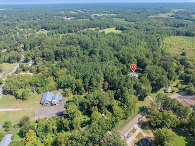 Aerial view of property's location featuring a forest