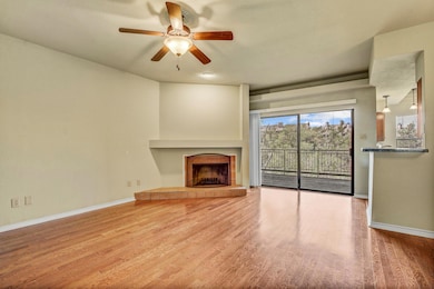 Unfurnished living room featuring ceiling fan, wo