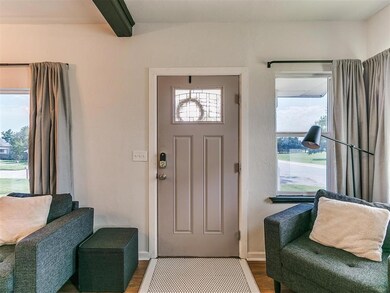 Entrance foyer with beamed ceiling and dark hardwo