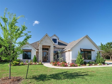 Modern home featuring stone siding, a front yard, and a shingled roof