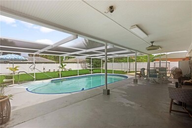 View of pool with a patio, a yard, and glass enclo