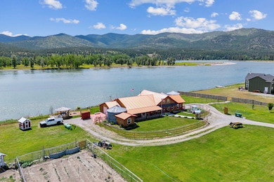 Birds eye view of property featuring Clarkfork River and mountain views