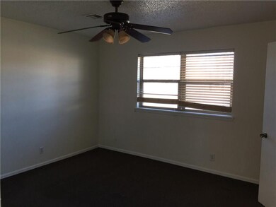 Back bedroom with blinds, ceiling fan, closet, cen