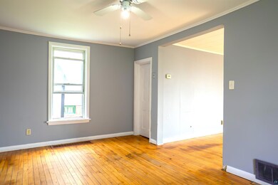 Spare room featuring ceiling fan, ornamental moldi