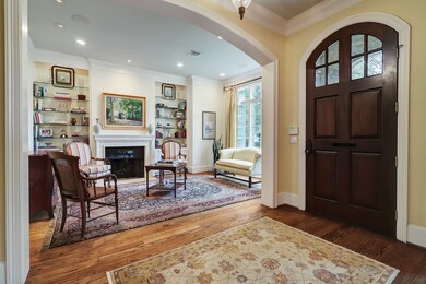 Solid mahogany door with glass panels in entry, double crown molding and arched openings are some of the classic details in this home.