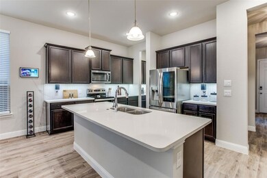The kitchen has gorgeous dark stained cabinets and
