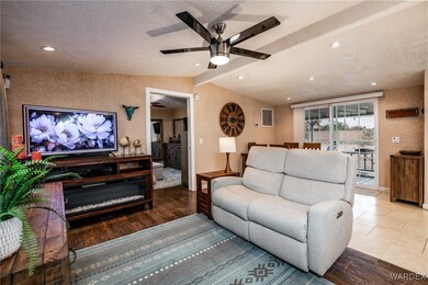 Living area with lofted ceiling with beams, visibl