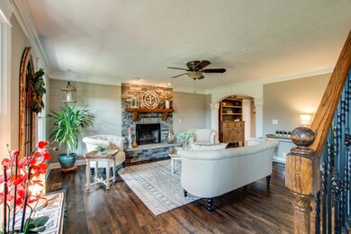 The living room is updated with awesome accents--a stone fireplace flanked with shiplap and gorgeous 3/4