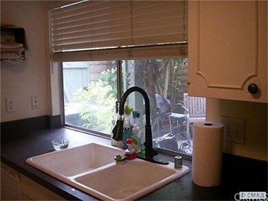 Kitchen window looks out into the private patio.